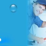 Plumber giving thumbs up after completing pipe repair under sink.