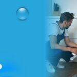Professional plumber repairing kitchen sink plumbing and inspecting drain pipes during a residential plumbing service