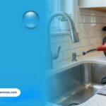 Professional drain cleaning equipment, including a drain auger and inspection camera, placed beside a kitchen sink for plumbing maintenance.