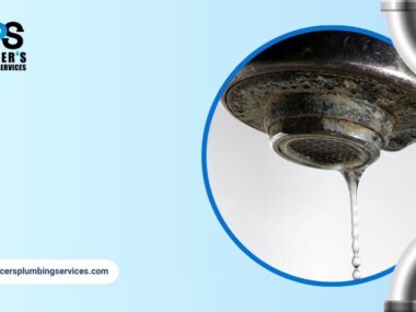 Close-up of faucet with mineral buildup and dripping water indicating hard water problems.