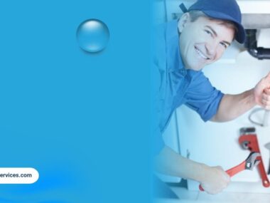 Plumber giving thumbs up after completing pipe repair under sink.