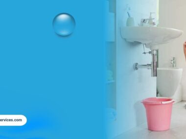 Woman calling plumber for bathroom leak with bucket under sink in apartment